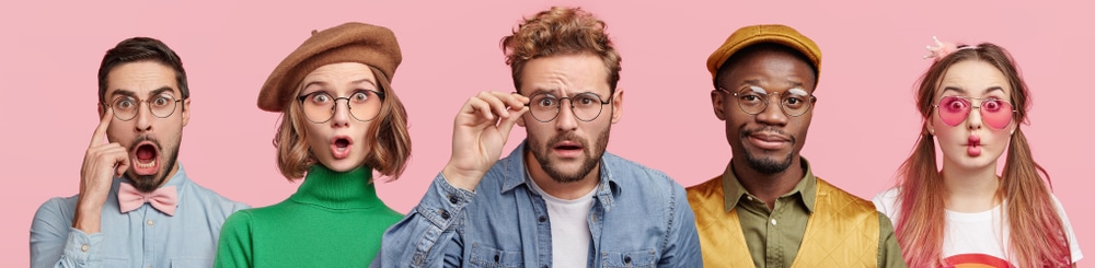 five people with glasses in front of pink background