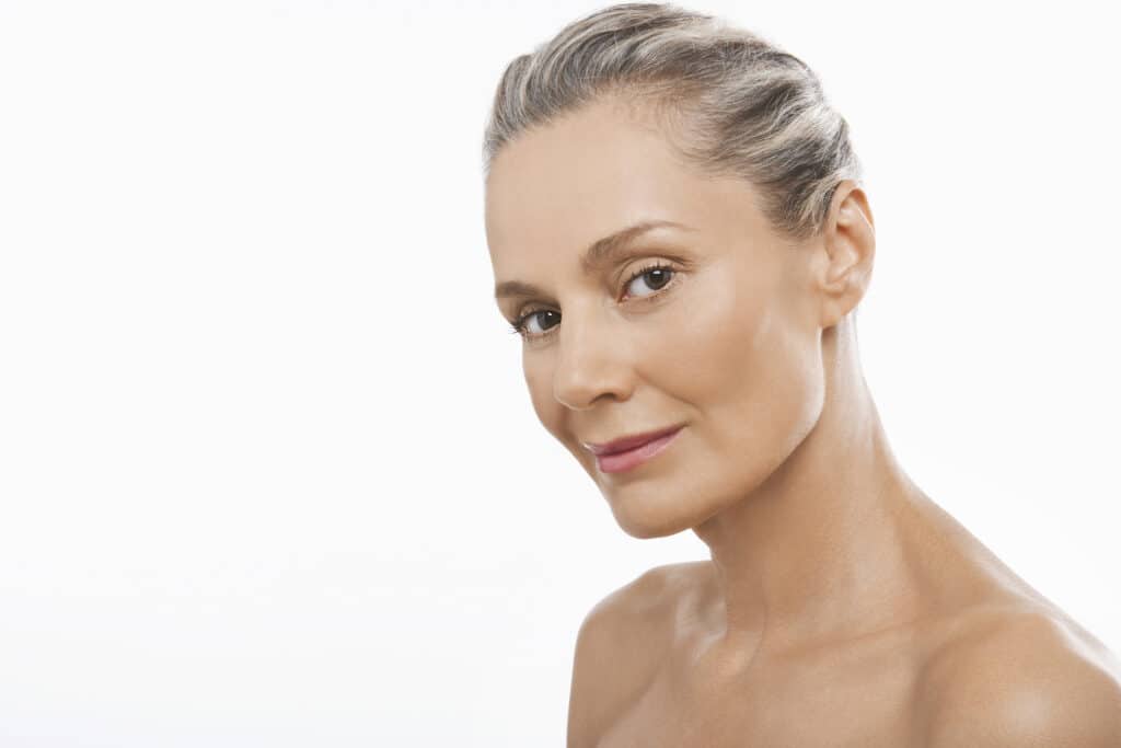 Mature woman has a sleek neck shape after skin tightening