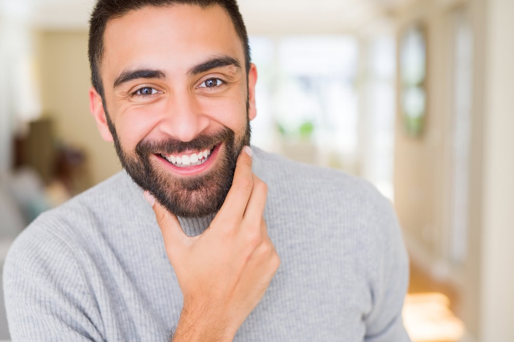 Young Latino man has ears that suit the harmony of his face.